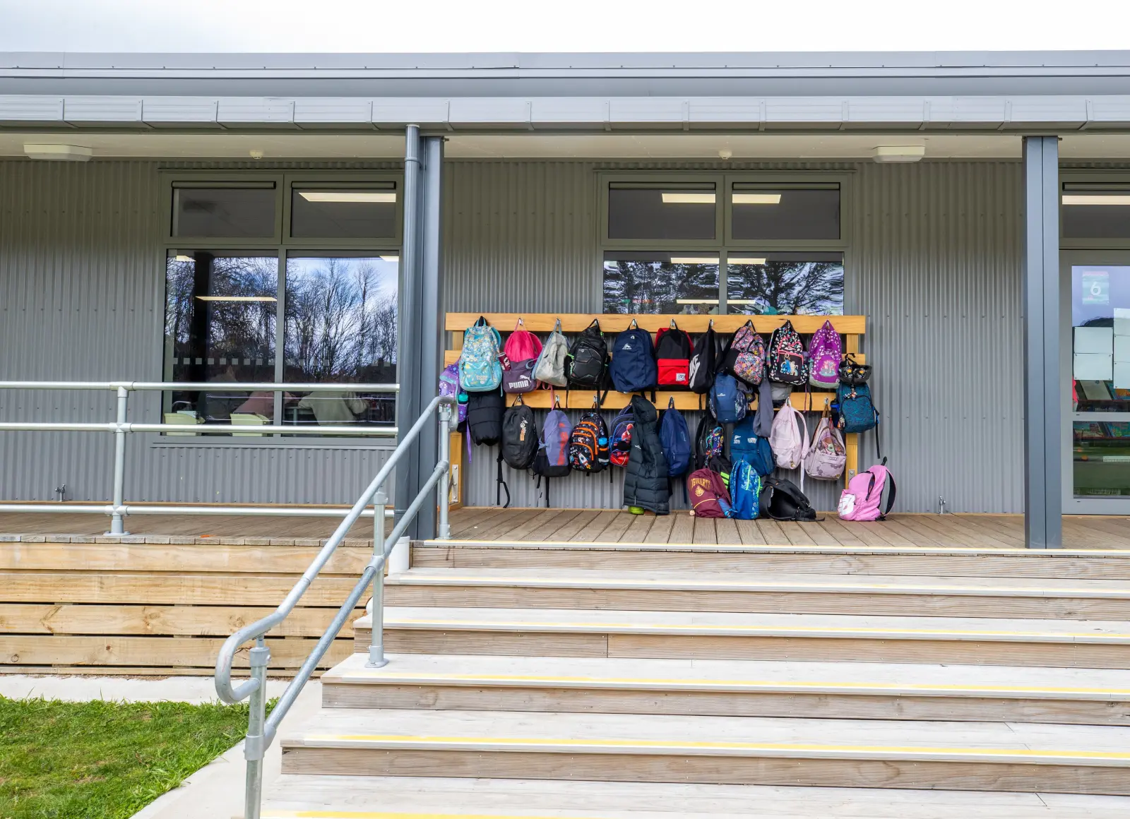 Backpacks on hooks outside classroom